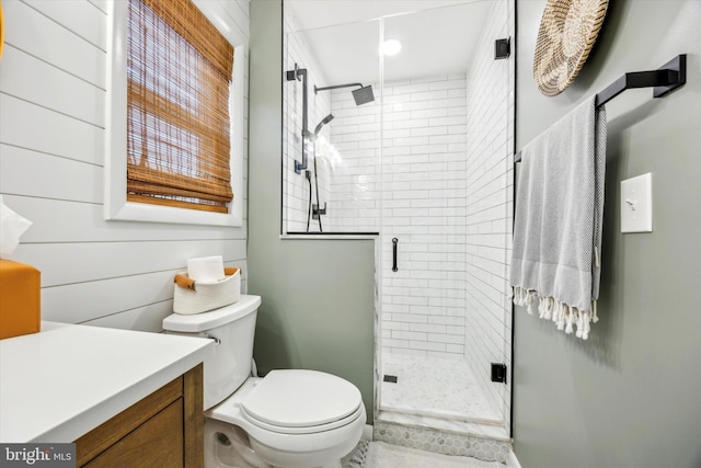 bathroom with vanity, a shower with door, and toilet