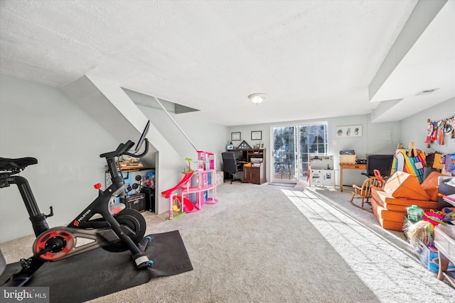 rec room with carpet and a textured ceiling