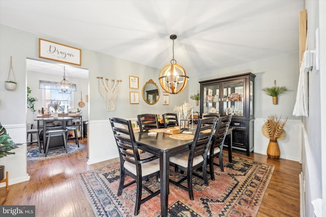 dining room with hardwood / wood-style flooring and a chandelier