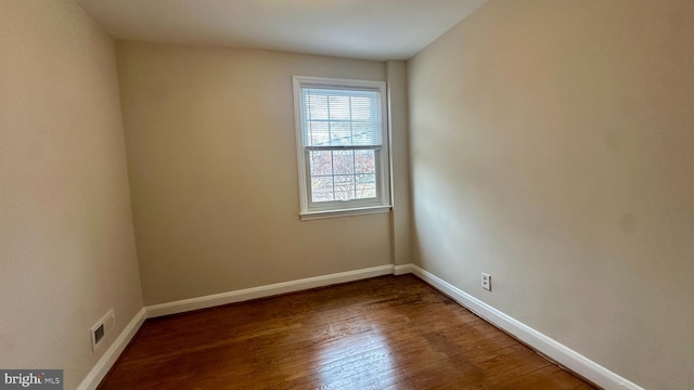 unfurnished room featuring dark hardwood / wood-style flooring