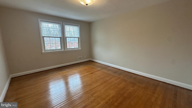 empty room with hardwood / wood-style floors