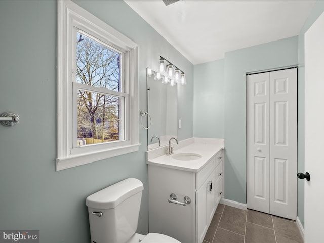 bathroom featuring vanity, toilet, and tile patterned flooring