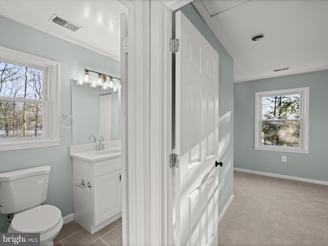 bathroom with tile patterned floors, vanity, and toilet