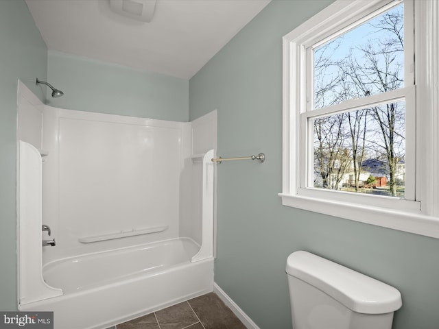 bathroom with shower / bathing tub combination, tile patterned floors, and toilet