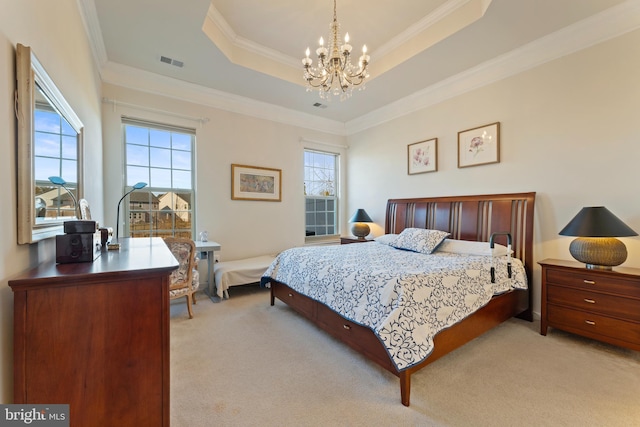 bedroom with multiple windows, a raised ceiling, visible vents, and light colored carpet