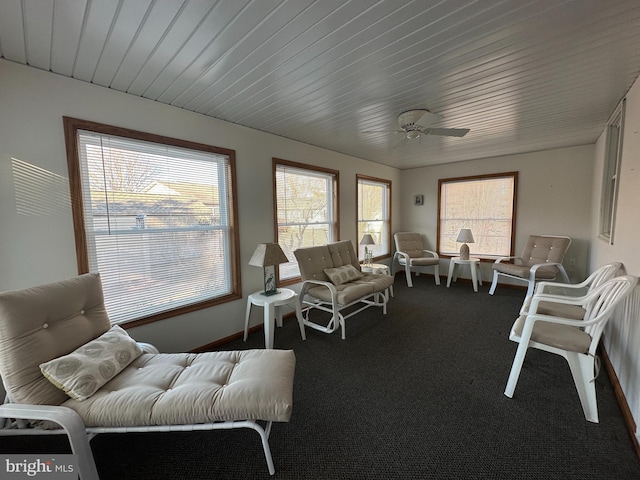 sunroom featuring wooden ceiling and a ceiling fan