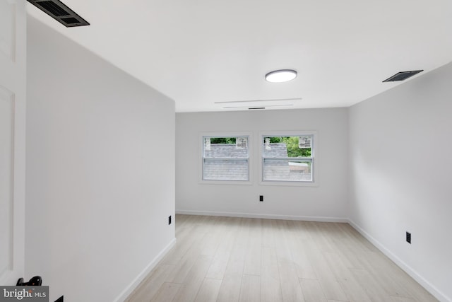 empty room with light hardwood / wood-style flooring