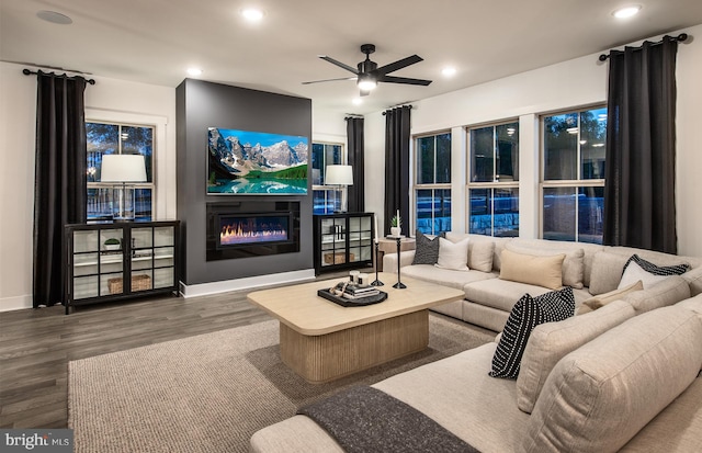 living room featuring hardwood / wood-style floors and ceiling fan