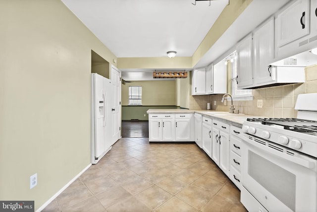 kitchen featuring white cabinetry, sink, backsplash, light tile patterned floors, and white appliances