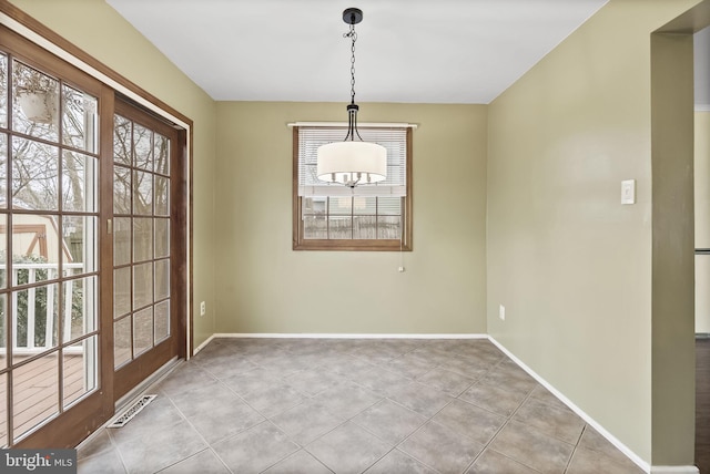 unfurnished dining area featuring light tile patterned floors