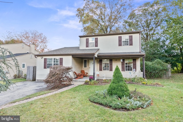 front of property featuring a porch and a front lawn