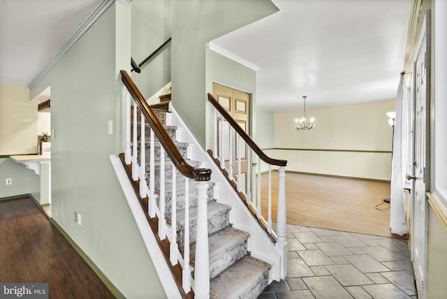 stairs featuring ornamental molding, wood-type flooring, and a notable chandelier