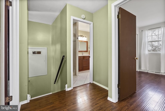 hall featuring wood-type flooring and sink