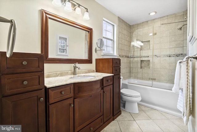 full bathroom with tile patterned flooring, bath / shower combo with glass door, vanity, and toilet