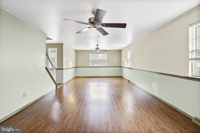 spare room with hardwood / wood-style flooring and crown molding