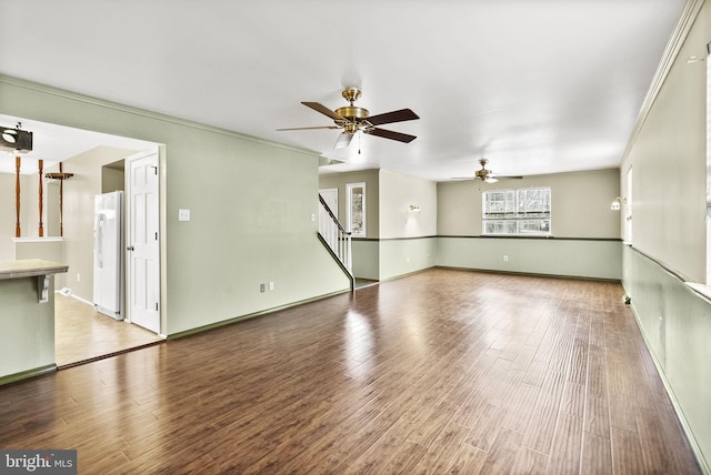 spare room with crown molding, ceiling fan, and hardwood / wood-style floors