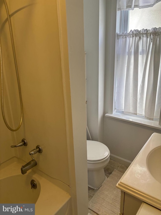 full bathroom featuring  shower combination, toilet, vanity, and a wealth of natural light