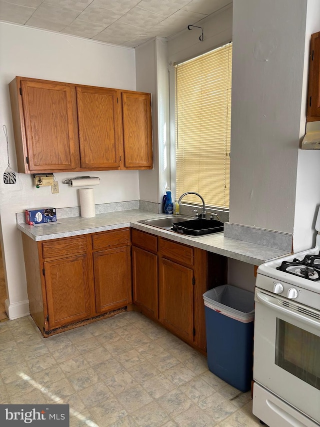 kitchen featuring sink and white gas stove