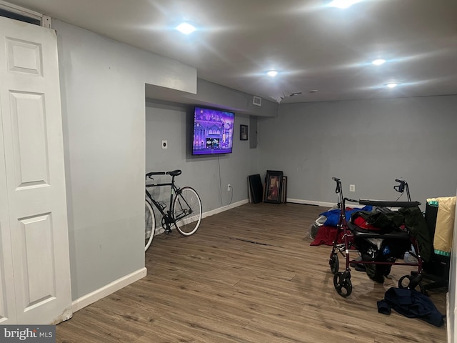 exercise room featuring hardwood / wood-style floors