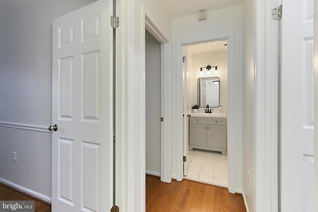 hallway featuring dark hardwood / wood-style flooring and sink