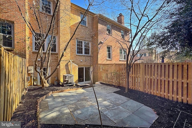 rear view of property featuring a patio and central AC unit