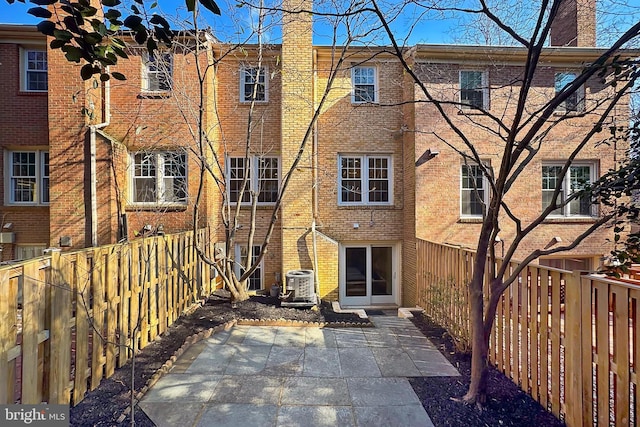 back of house with cooling unit and a patio area