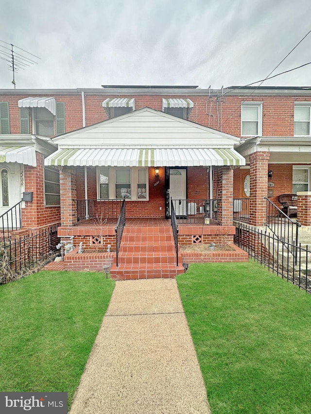 view of front facade with covered porch and a front lawn