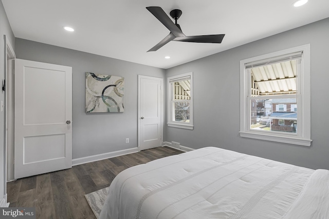 bedroom with dark hardwood / wood-style floors and ceiling fan