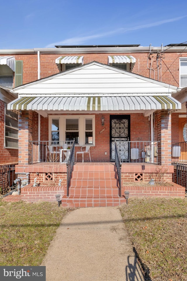 view of front of home featuring covered porch and a front lawn