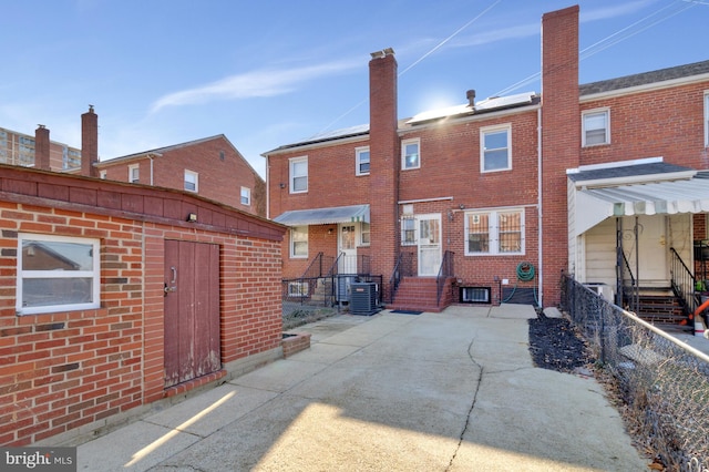 rear view of house with central AC