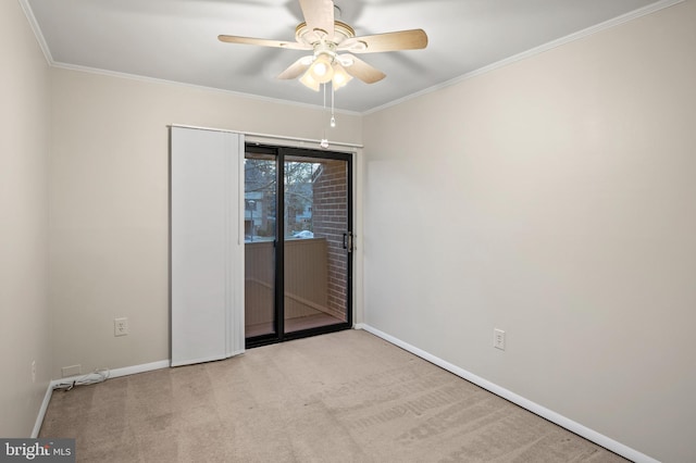 carpeted empty room featuring ceiling fan and ornamental molding