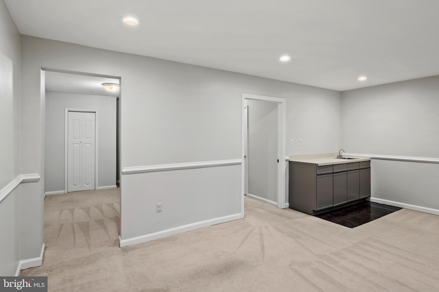 carpeted spare room with sink