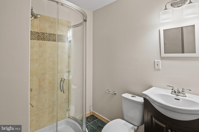 bathroom with vanity, an enclosed shower, tile patterned floors, and toilet