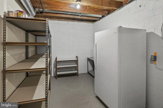 basement featuring white fridge