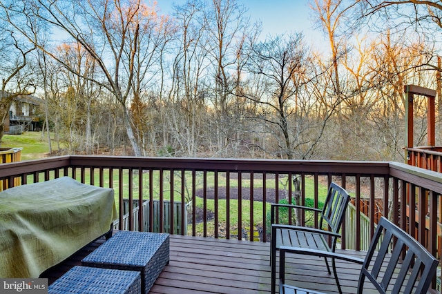 wooden terrace featuring a lawn