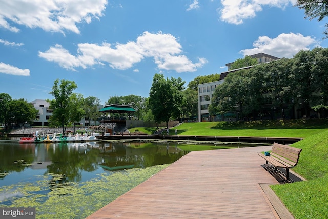 view of dock featuring a yard and a water view