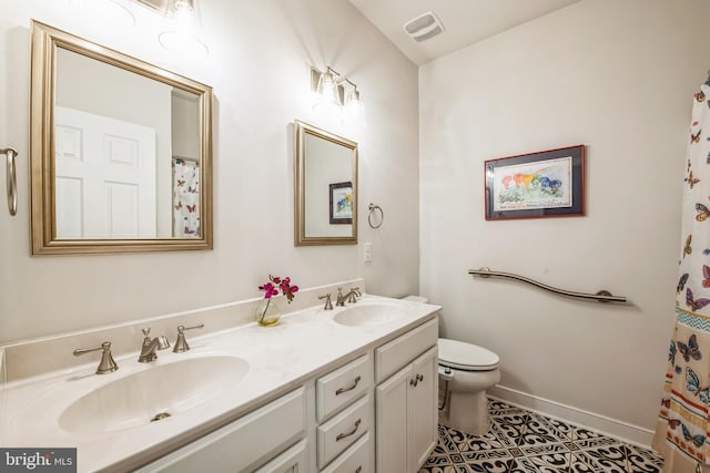 bathroom with vanity, tile patterned floors, and toilet