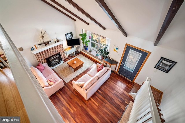 living room featuring a fireplace, dark hardwood / wood-style floors, and beamed ceiling