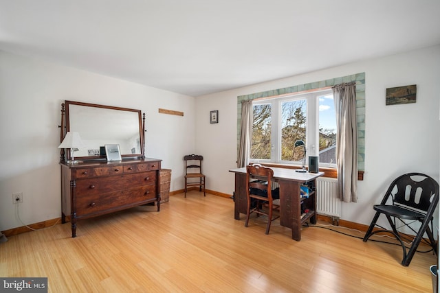 interior space with radiator and light hardwood / wood-style floors