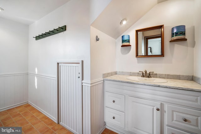 bathroom with vanity and vaulted ceiling