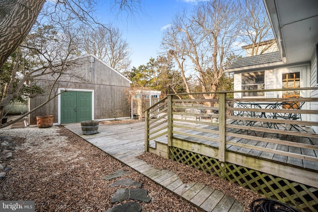 wooden terrace featuring an outbuilding