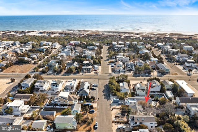 aerial view with a water view and a beach view