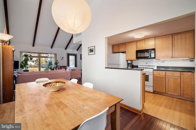 dining space featuring beamed ceiling, high vaulted ceiling, and hardwood / wood-style flooring