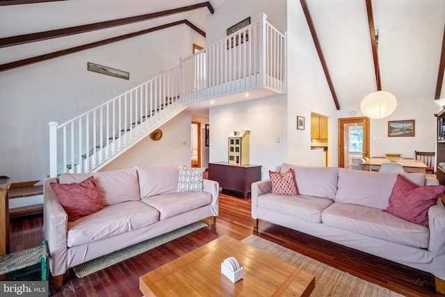 living room featuring beamed ceiling, wood-type flooring, and high vaulted ceiling