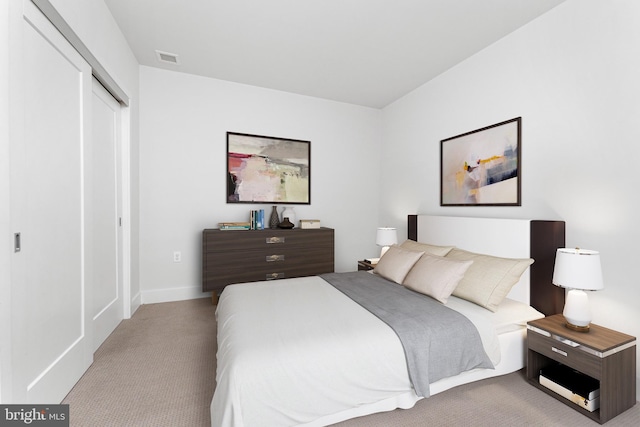 bedroom featuring light carpet