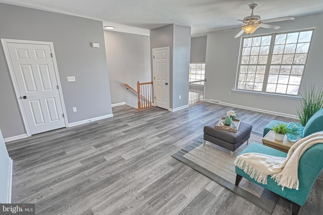 living room featuring hardwood / wood-style floors and ceiling fan