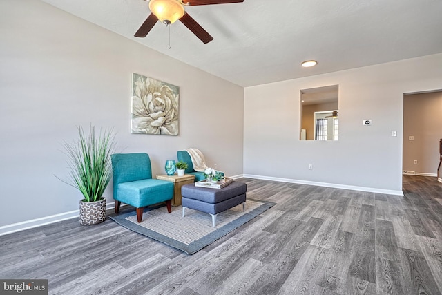 sitting room with dark hardwood / wood-style floors and ceiling fan