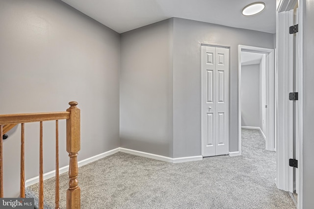 hallway with light colored carpet