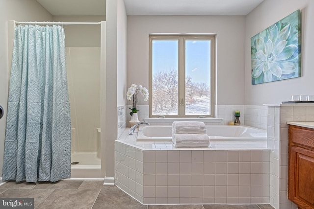 bathroom featuring vanity, separate shower and tub, and a healthy amount of sunlight