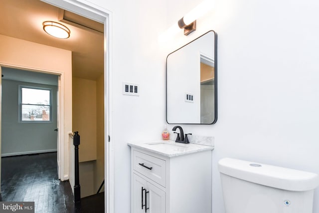 bathroom featuring hardwood / wood-style flooring, vanity, and toilet